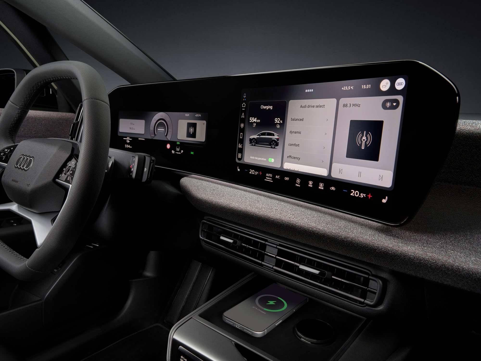 The 11.9 inch cockpit and 12.8 inch touch display, above the cooled phone tray