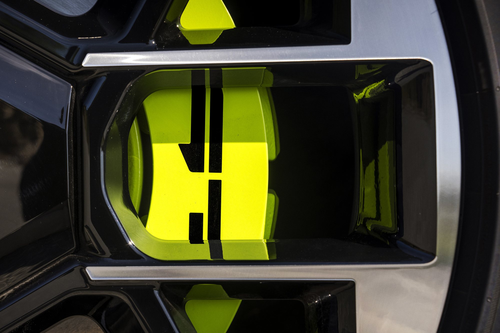 A neon-green calliper behind a 20 inch wheel