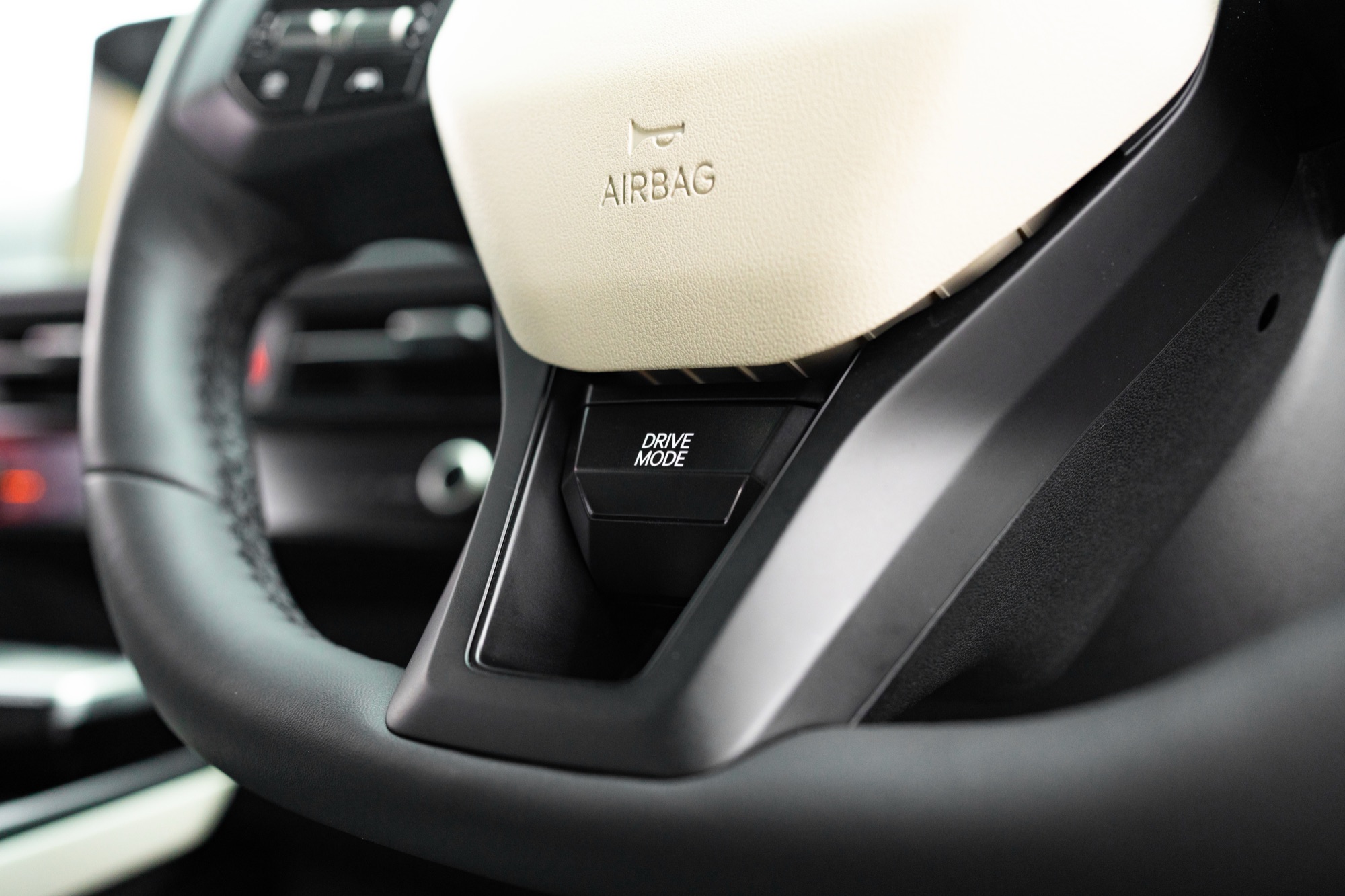 The drive mode button on the steering wheel