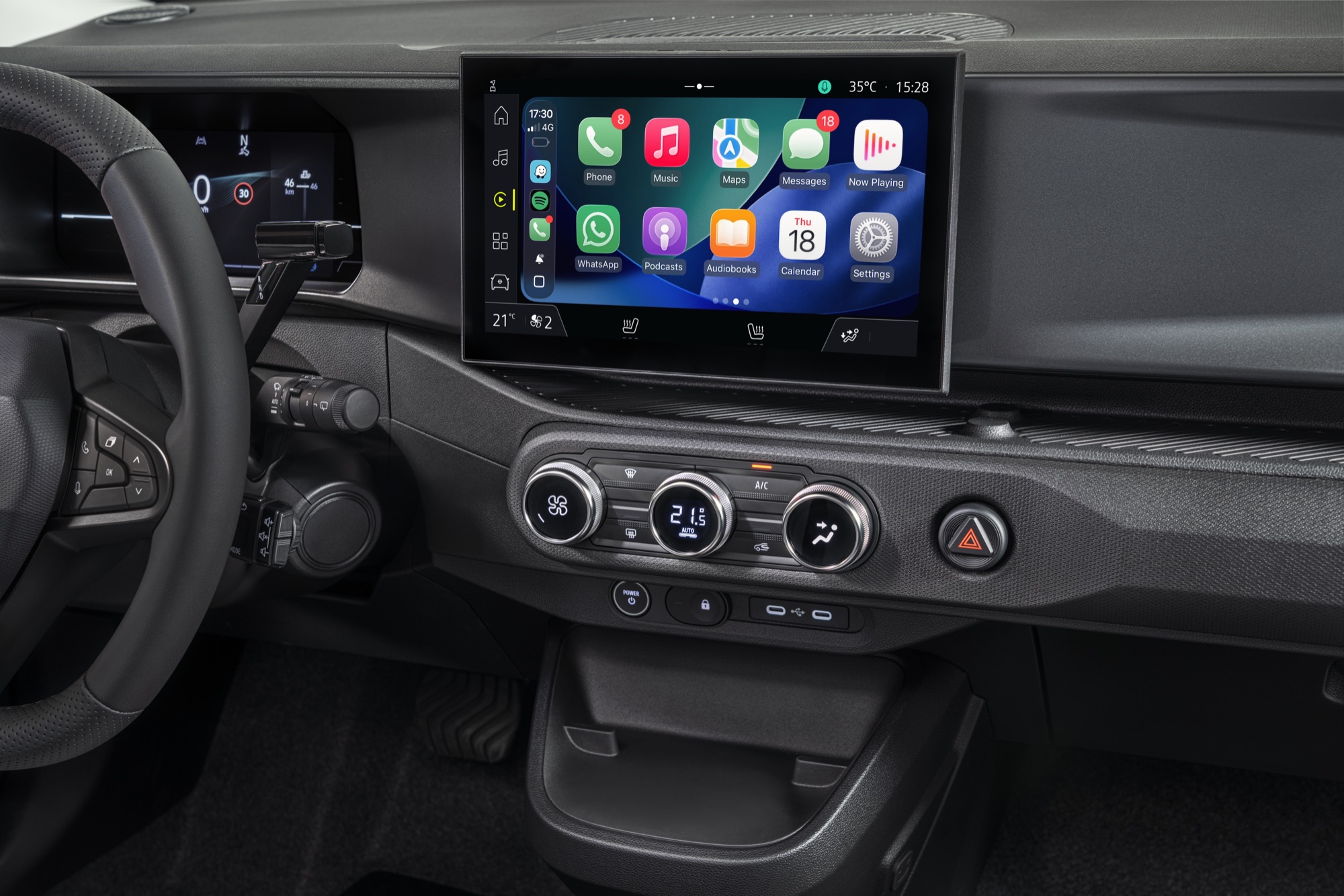 Apple CarPlay on the 10-inch screen, above the climate dials