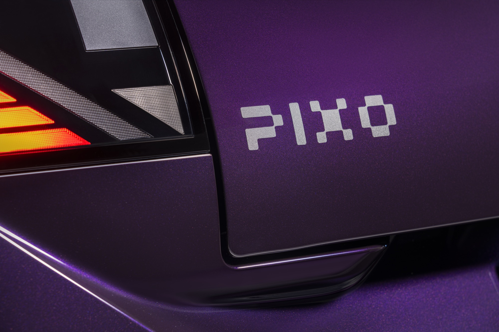 The PIXO name, set in pixels beside the tail light