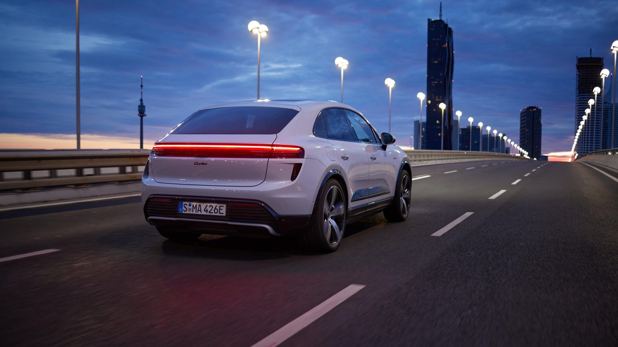 Macan Electric on the road at dusk
