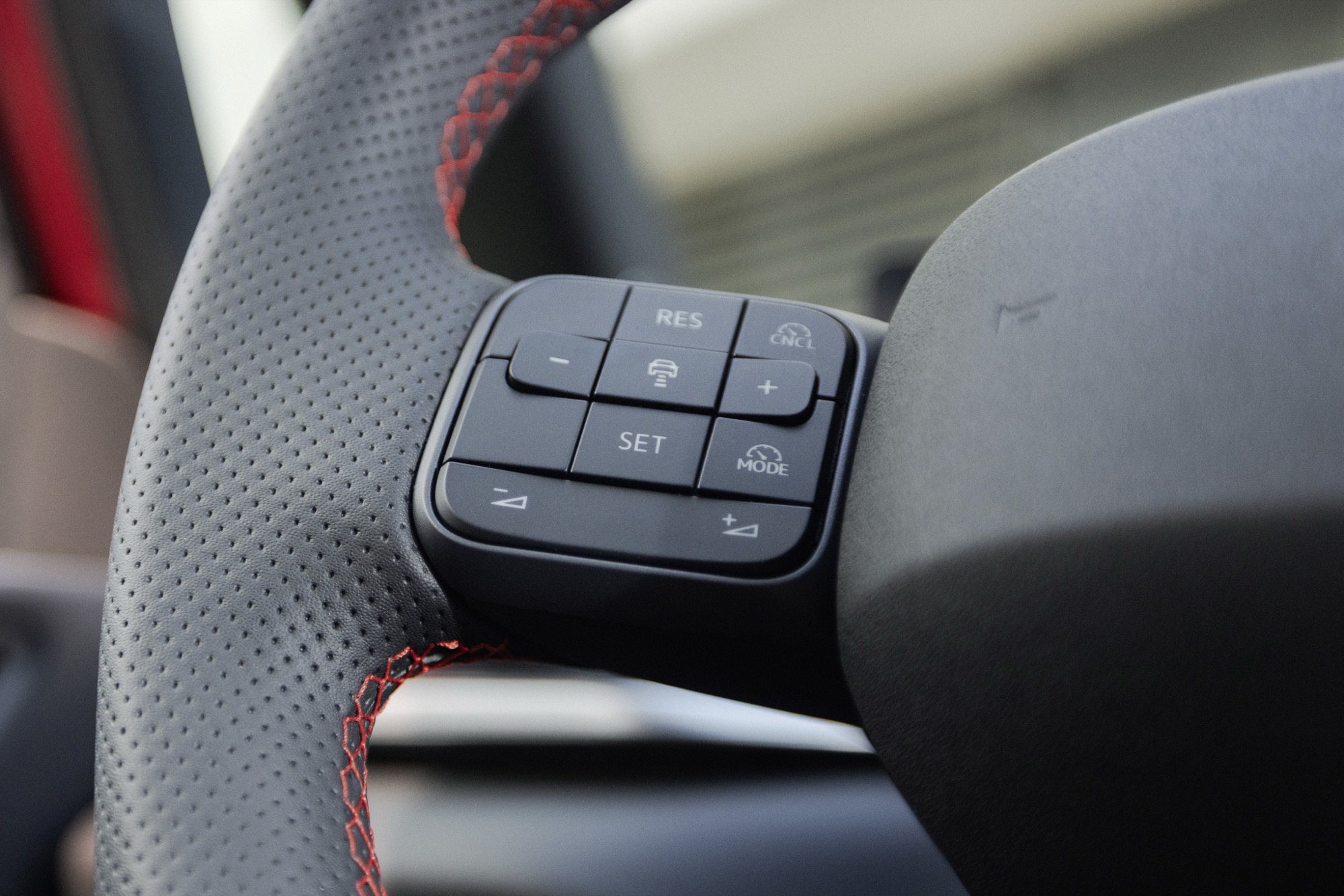 The Travel Assist controls, and the red stitching around them